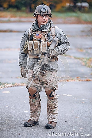 Soldier in protective gear with a rifle in his hands Editorial Stock Photo